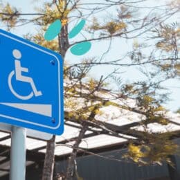 Photo shows a sign hinting at a wheelchair ramp. This symbolizes accessibility.