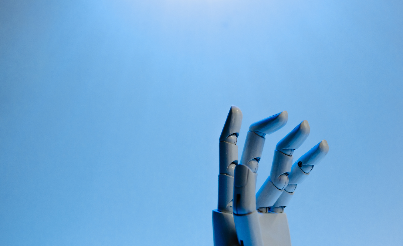 On a blue background a robot hand reaches up, to reflect AI for this AI glossary.