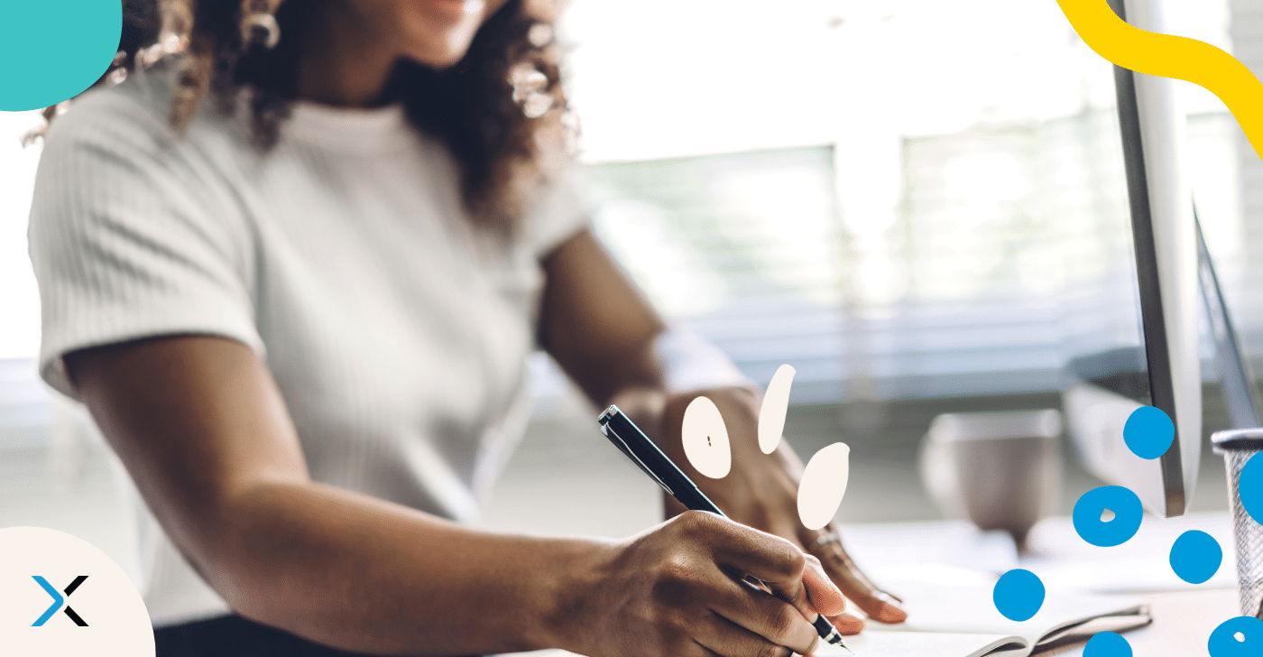 A hand holding a pen symbolizes technical business communication.