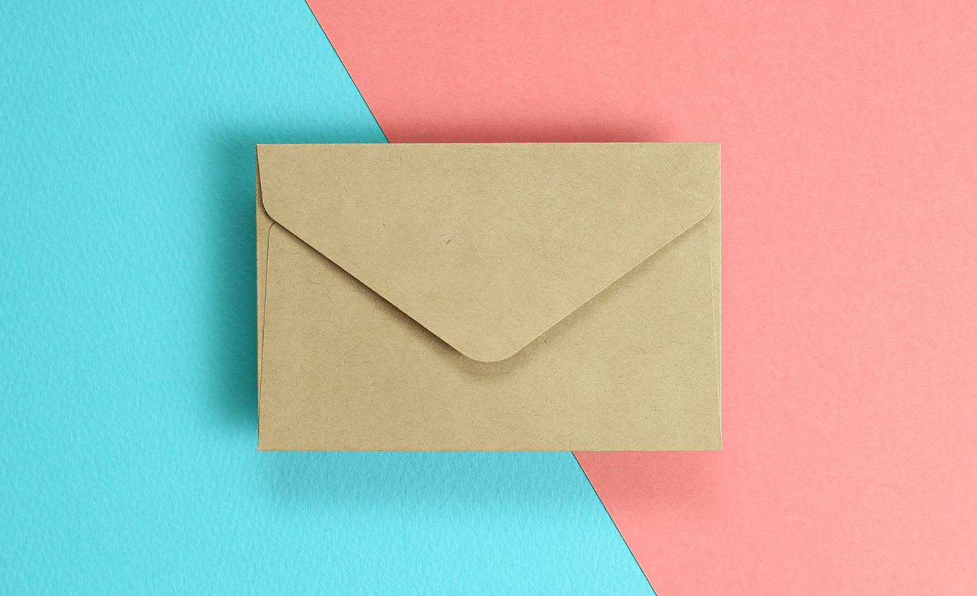 On a bright blue and pink background a beige envelope is centrally displayed to represent how to write effective emails.