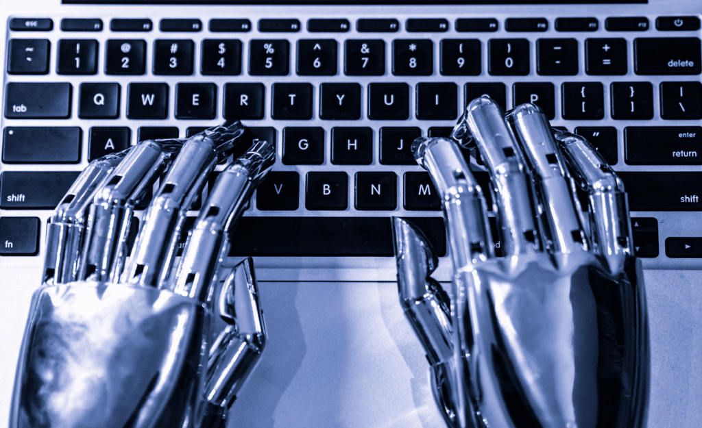 Robotic hands typing on a keyboard.