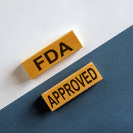 Featured image that shows two wooden bricks on a black-white background with copy on them: "FDA APPROVED"