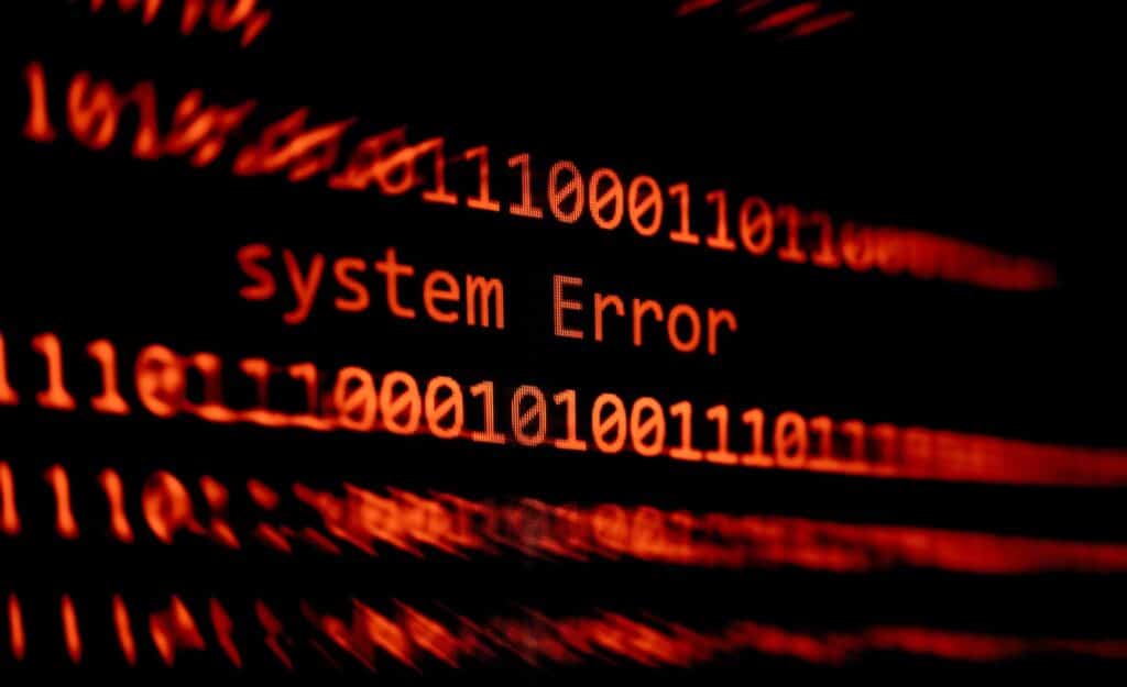 A "system error" message is displayed alongside lines of code in red on a black background.