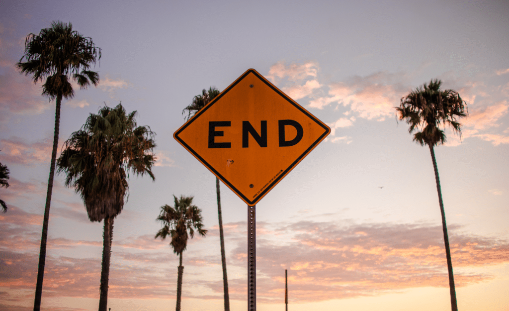 What happened to AI taking over the world blog image. An end of road sign in front of palm trees.