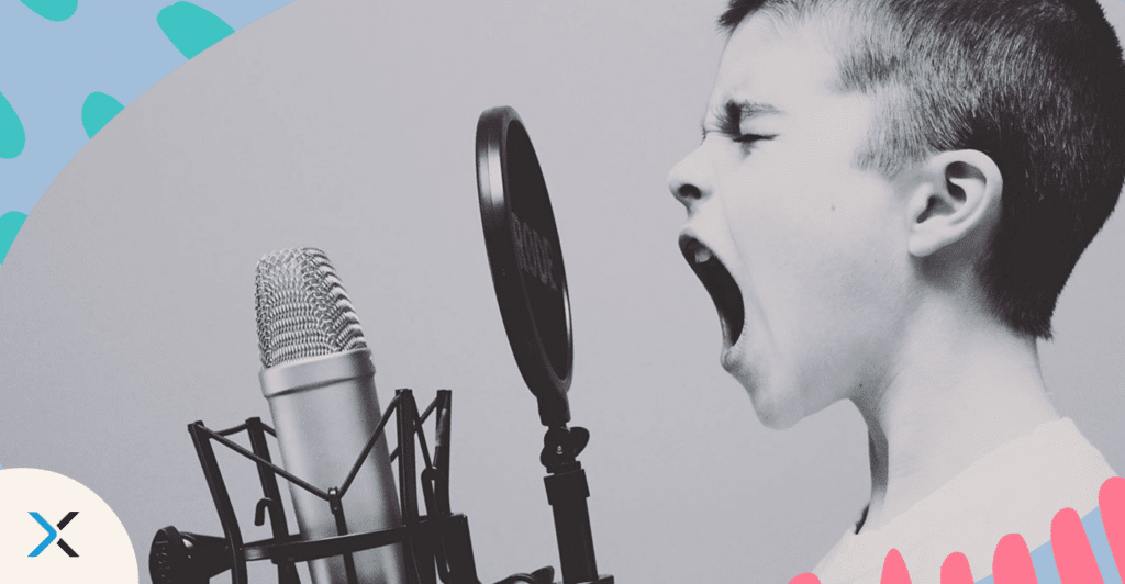 A young child testing tone of voice into a microphone