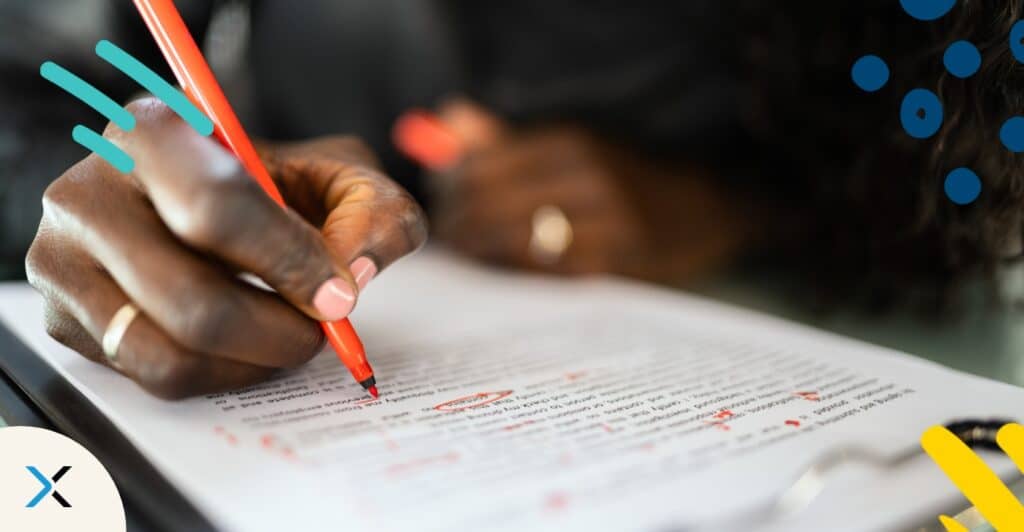 The hand of a person editing some copy symbolizes AI sentence rewriter tools.